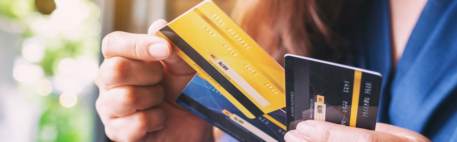 a woman hold her credit/debit cards